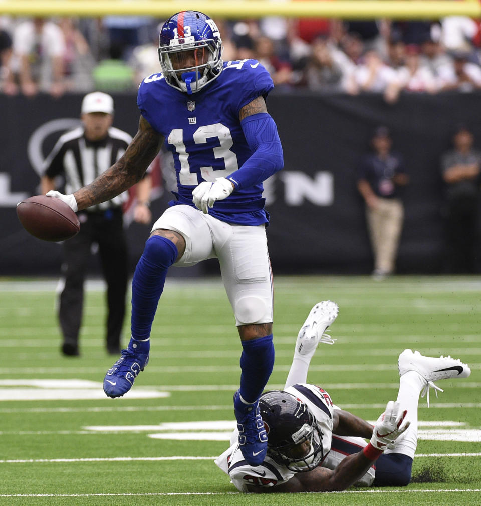 New York Giants wide receiver Odell Beckham Jr. (13) breaks away from Houston Texans defensive back Kareem Jackson (25) after catching a pass during the first half of an NFL football game Sunday, Sept. 23, 2018, in Houston. (AP Photo/Eric Christian Smith)