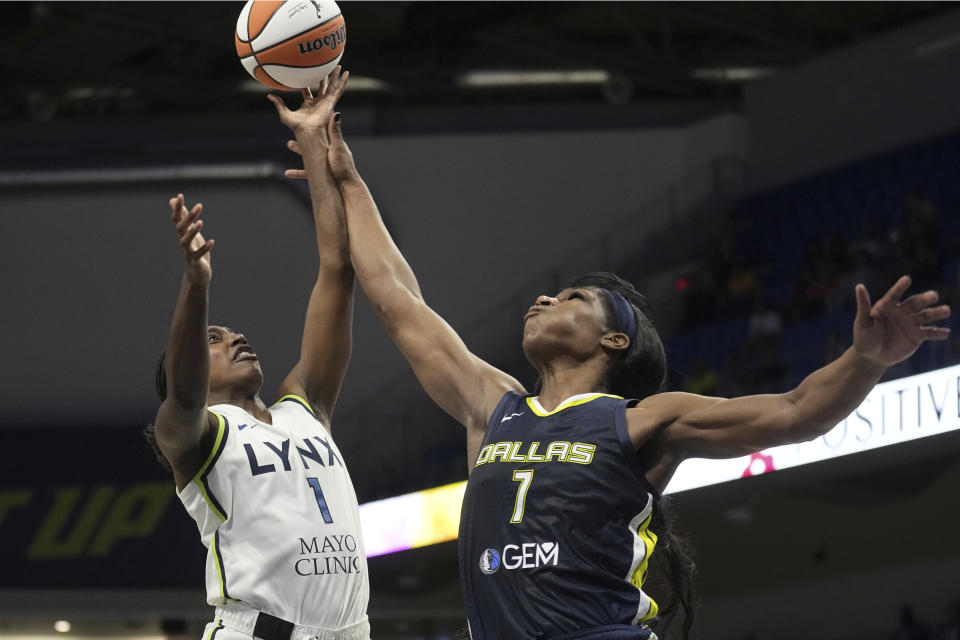 Minnesota Lynx guard Diamond Miller, left, is fouled by Dallas Wings center Teaira McCowan, right, while shooting in the second half of a WNBA basketball game, Thursday, Aug. 24, 2023, in Arlington, Texas. (AP Photo/Tony Gutierrez)