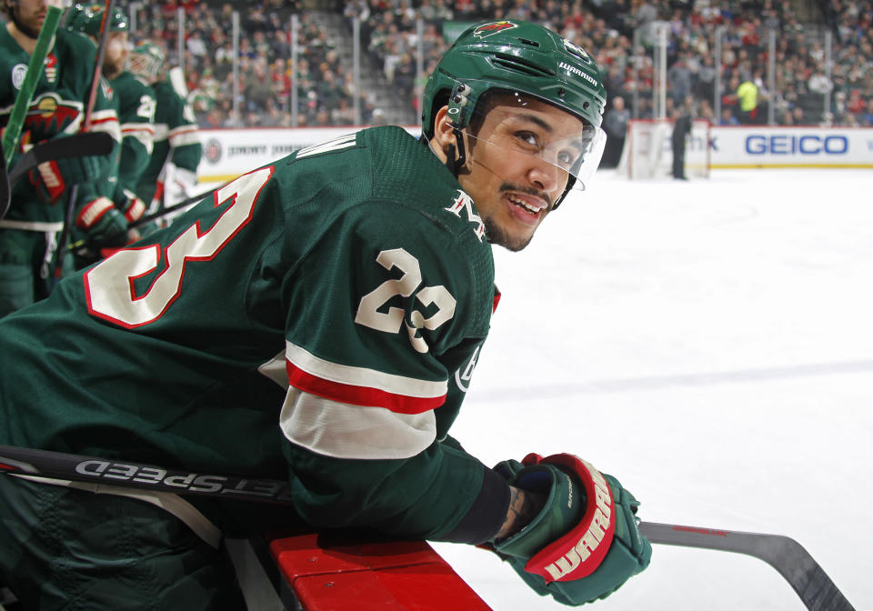 J.T. Brown #23 of the Minnesota Wild looks on from the bench during TV timeout in a game with the Nashville Predators at Xcel Energy Center on March 25, 2019