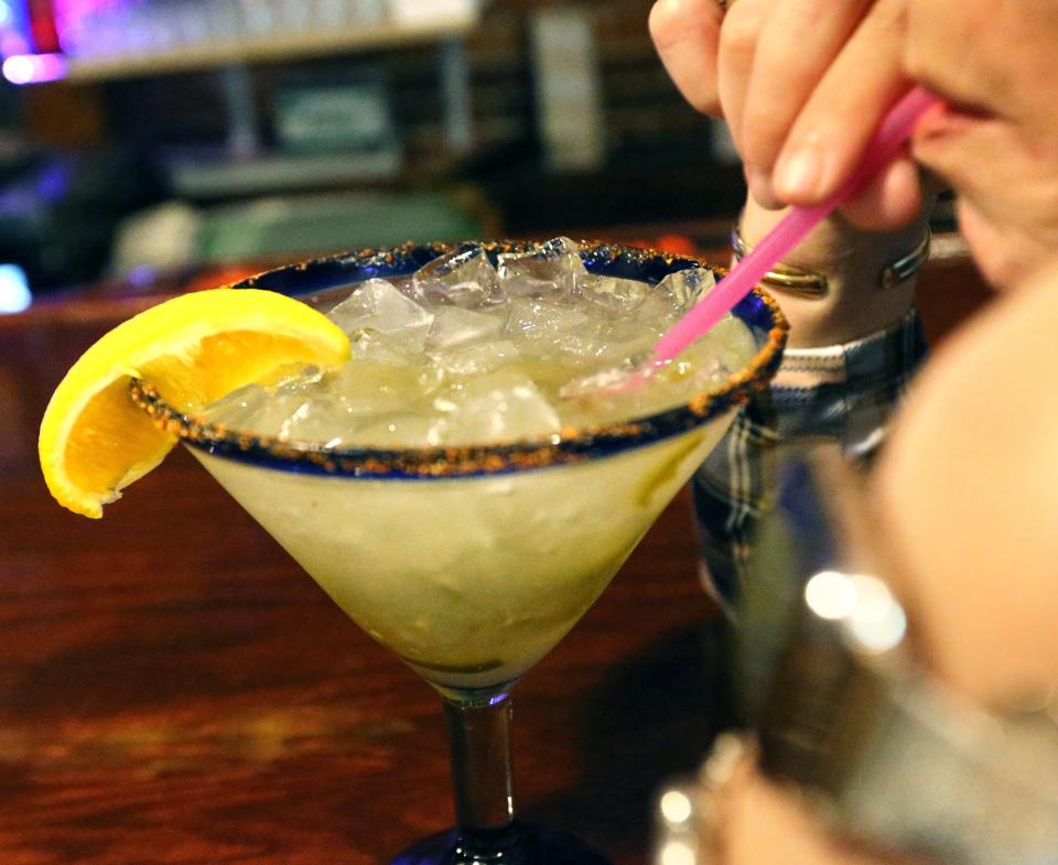 A customer sips a jalapeno spicy margarita she ordered at Cinco de Mayo Bar & Grill in Dover Monday, July 11, 2022.