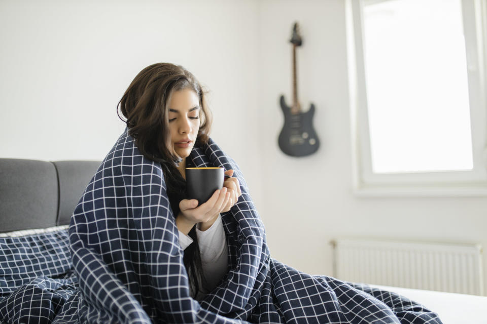 woman in bed with a blanket over her body