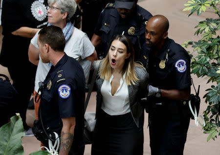 A protester is arrested during a demonstration in opposition to U.S. President Donald Trump's Supreme Court nominee Brett Kavanaugh on Capitol Hill in Washington, U.S., September 20, 2018. REUTERS/Yuri Gripas