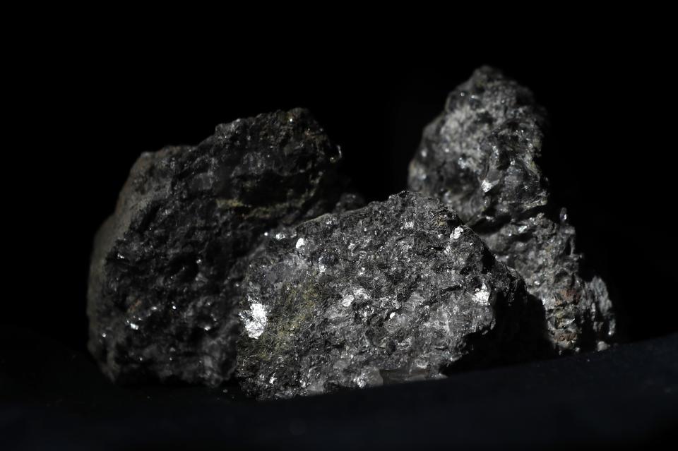 FILE - Pieces of lithium sparkle in an ore sample in Prague, Czech Republic, on Tuesday, March 28, 2017. Recent explorations confirmed large deposits of lithium near the village of Cinovec northwest Czech Republic. Lithium — the lightest metal on Earth — was discovered by Swedish chemist Johan August Arfwedson more than 200 years ago. Since then, lithium and its compounds have been used in everything from psychiatric medicine to lubricating grease. (AP Photo/Petr David Josek, File)