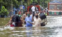 Mumbai: People wade through a waterlogged street at Parel area, after heavy monsoon rain, in Mumbai, Wednesday, Sept. 23, 2020. (PTI Photo)(PTI23-09-2020_000098B)