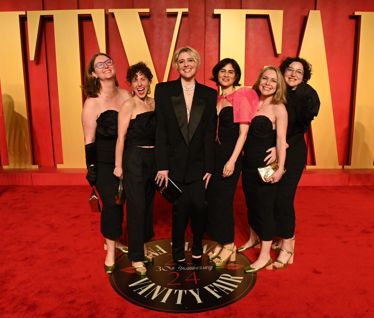 BEVERLY HILLS, CALIFORNIA - MARCH 10: Greta Gerwig (C) and guests attend the 2024 Vanity Fair Oscar Party Hosted By Radhika Jones at Wallis Annenberg Center for the Performing Arts on March 10, 2024 in Beverly Hills, California. (Photo by Jon Kopaloff/Getty Images for Vanity Fair)