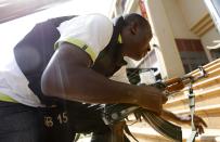 A policeman takes up position during a shootout with armed men at the Westgate shopping mall in Nairobi September 21, 2013. (REUTERS/Thomas Mukoya)