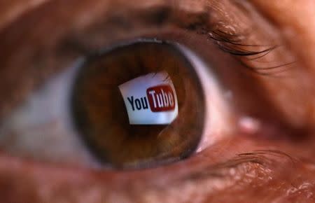 A picture illustration shows a YouTube logo reflected in a person's eye, in central Bosnian town of Zenica, early June 18, 2014.REUTERS/Dado Ruvic