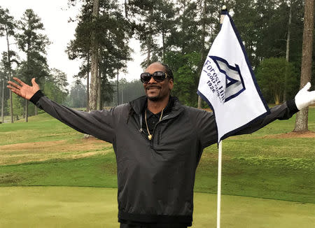 Rapper Snoop Dogg reacts after taking a few practice swings at a golf course in Augusta, Georgia, U.S., April 5, 2017. REUTERS/Rory Carroll