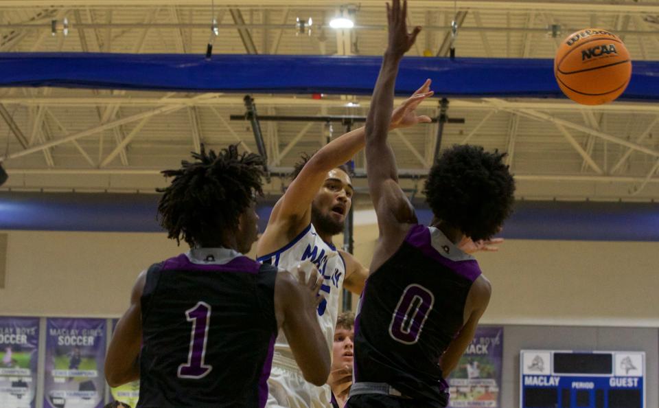 Maclay junior forward Blaise Wallace (15) passes through traffic in a game against Crossroad Academy on Jan. 14, 2022, at Maclay School. The Marauders won 65-51.