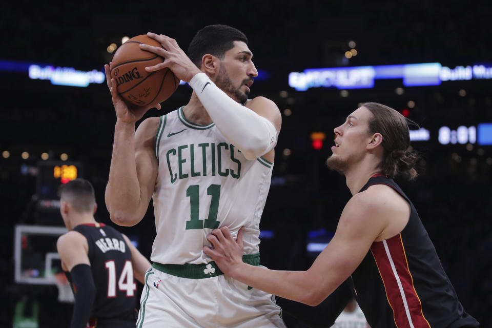 Boston Celtics center Enes Kanter (11) looks to pass as he is covered by Miami Heat forward Kelly Olynyk, right, during the first half of an NBA basketball game in Boston, Wednesday, Dec. 4, 2019. (AP Photo/Charles Krupa)