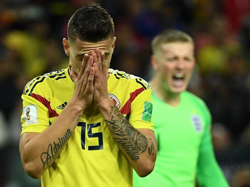 Mateus Uribe reacts after missing to score a penalty kick next to England's goalkeeper Jordan Pickford (AFP/Getty Images)