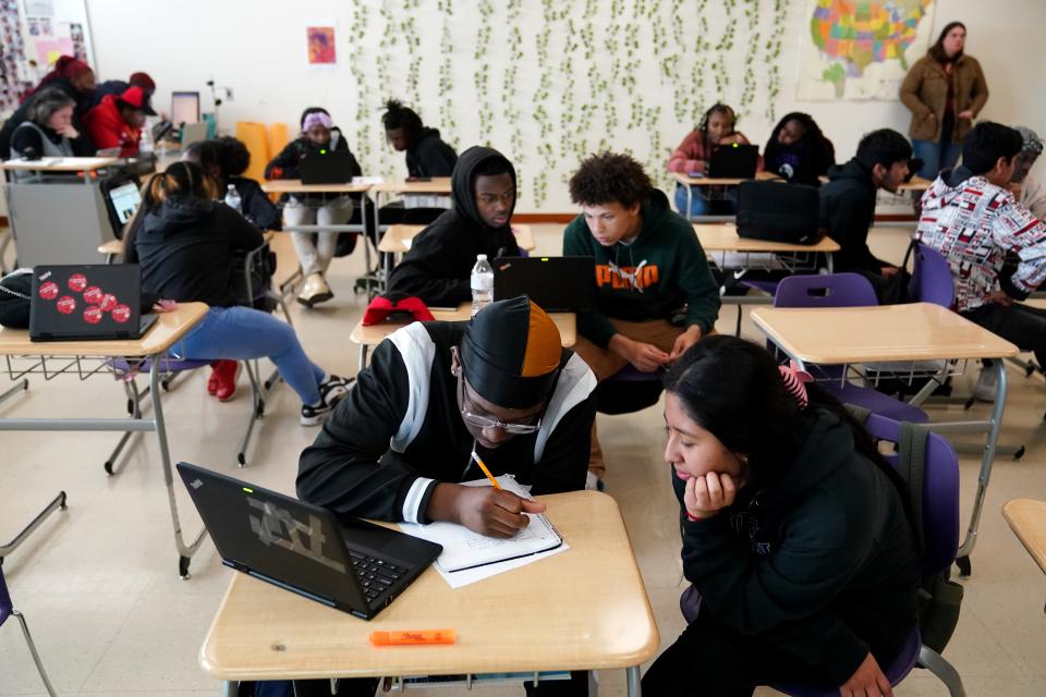 Leonard Dangerfield, center, goes over a class exercise with a classmate during a lesson on Ohio House Bill 611 in Bethany Cole's 11th-grade social studies class, Monday, April 18, 2022, at Aiken High School in Cincinnati.