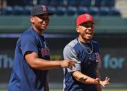 Jul 7, 2018; Kansas City, MO, USA; Boston Red Sox right fielder Mookie Betts (right) and third baseman Rafael Devers (left) look on during batting practice, prior to a game against the Kansas City Royals at Kauffman Stadium. Mandatory Credit: Peter G. Aiken/USA TODAY Sports