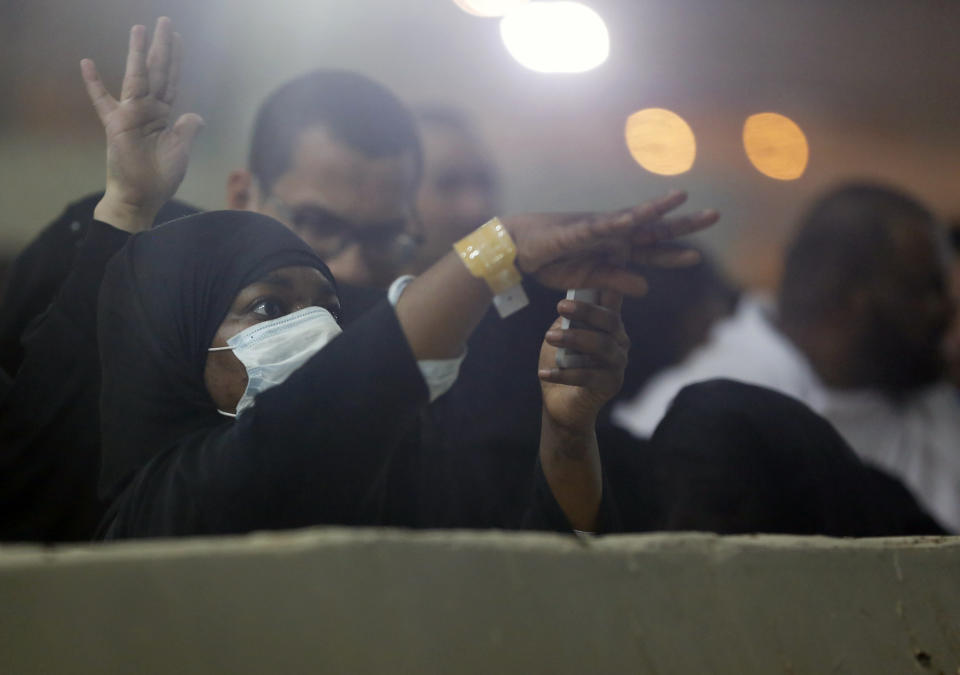 Muslim pilgrims cast stones at a pillar symbolizing the stoning of Satan, in a ritual called "Jamarat," the last rite of the annual hajj, on the first day of Eid al-Adha, in Mina near the holy city of Mecca, Saudi Arabia, Sunday, Aug. 11, 2019. The hajj is required of all Muslims to perform once in their lifetime if they are financially and physically able. (AP Photo/Amr Nabil)