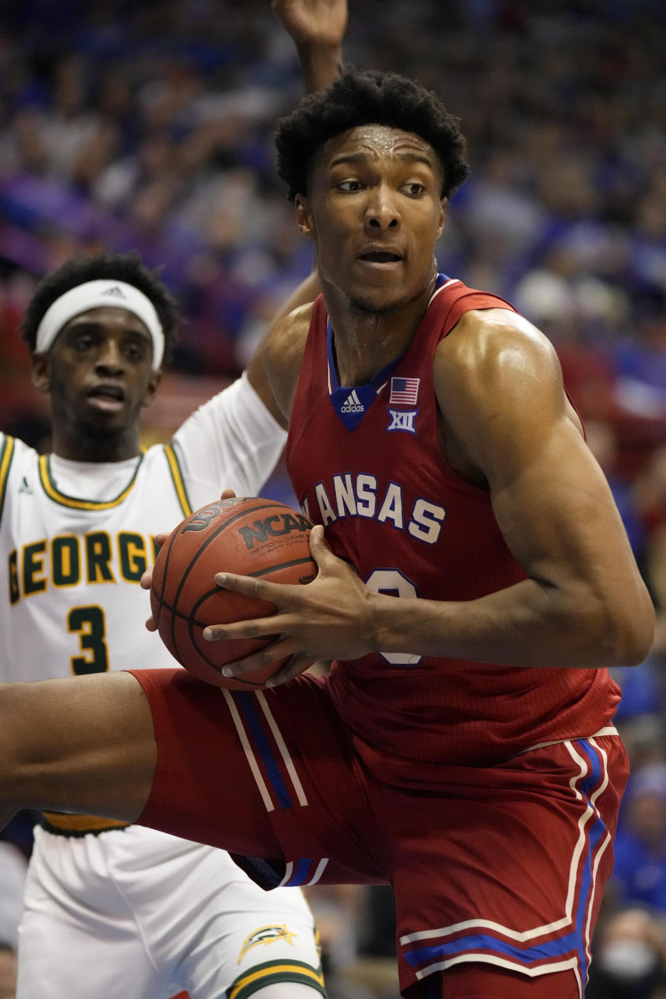 Kansas forward David McCormack, right, rebounds against George Mason guard Davonte Gaines (3) during the first half of an NCAA college basketball game in Lawrence, Kan., Saturday, Jan. 1, 2022. (AP Photo/Orlin Wagner)