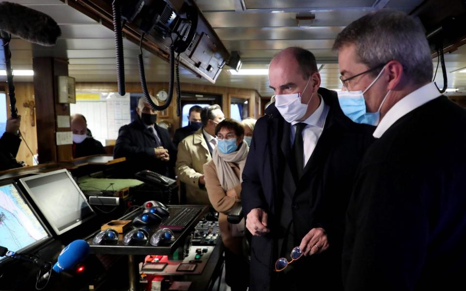 French Prime Minister Jean Castex (C) speak to crew members on board a fishing ship during a visit on the preparations ahead of the end of the Brexit transition period  - AFP