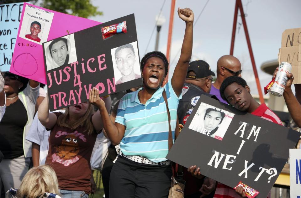 Protestors Lakesha Hall, 32, center, and her son, Calvin Simms, 12, right, gather early for a rally for Trayvon Martin, who was fatally shot by a neighborhood watch captain at Fort Mellon Park in Sanford, Fla.