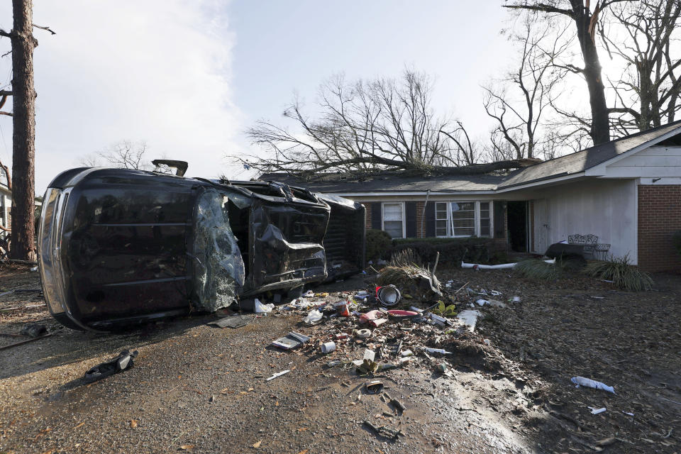 CORRECTS DAY OF WEEK TO THURSDAY, NOT WEDNESDAY - A vehicle is upended and debris is strewn about follow a tornado near Meadowview elementary school Thursday, Jan. 12, 2023 in Selma Ala. (AP Photo/Butch Dill)