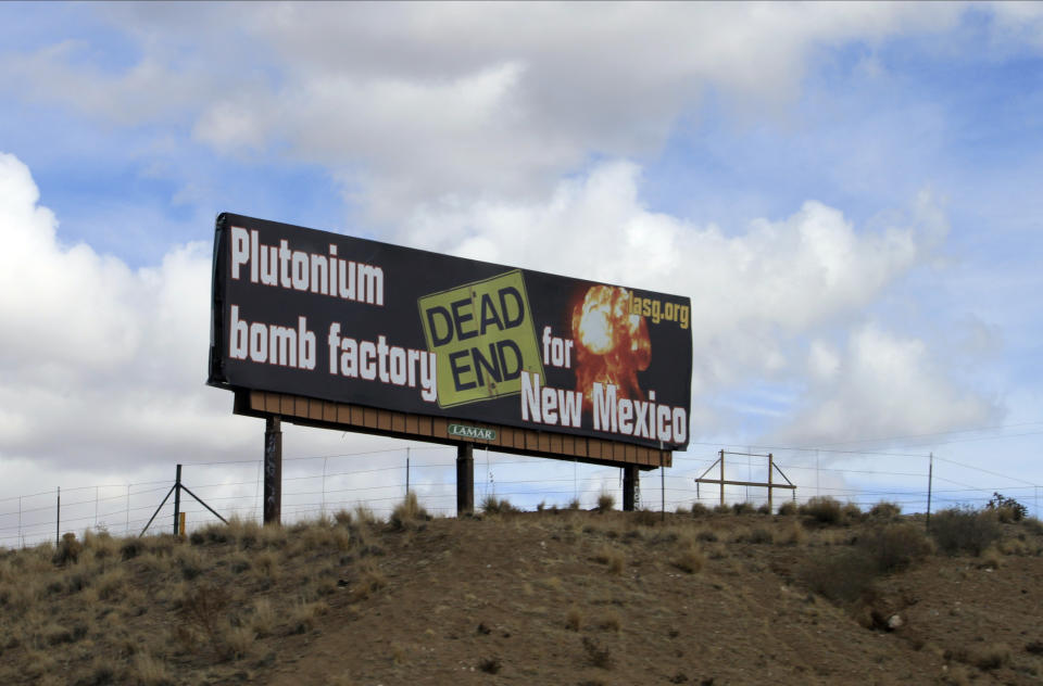 The Los Alamos Study Group takes aim at the U.S. government's plans to ramp up production of plutonium cores for the nation's nuclear arsenal with this billboard near Bernalillo, N.M., Wednesday, Feb. 17, 2021. The work will be split between Los Alamos National Laboratory in northern New Mexico and the Savannah River Site in South Carolina. (AP Photo/Susan Montoya Bryan)