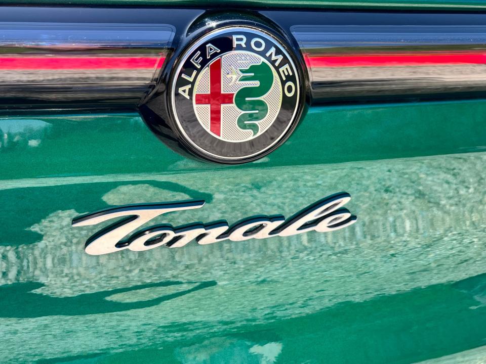 Alfa Romeo's badge, including the non-electrified version of the Biscione heraldic serpent.