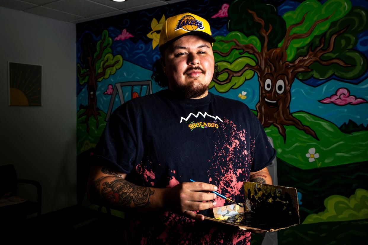 Siriaco "Siricasso" Garcia stands for a portrait as he paints a mural at Midwest Autism Center in West Des Moines.