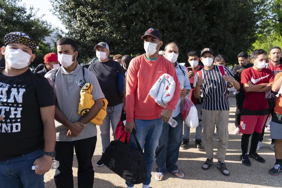 FILE - Migrants hold Red Cross blankets after arriving at Union Station near the U.S. Capitol from Texas on buses, April 27, 2022, in Washington. The Pentagon has rejected a request from the District of Columbia seeking National Guard assistance for the thousands of migrants being bused to the city from two southern states. (AP Photo/Jose Luis Magana, File)