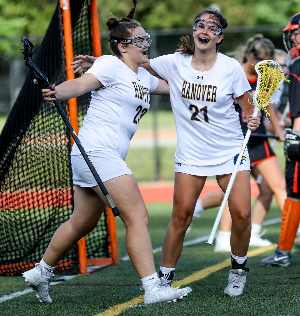 Hanover's Kylie Campbell (21) celebrates a goal with teammate Samantha Burke during a game in the Division 3 state tournament against Middleboro on Tuesday, June 7, 2022.