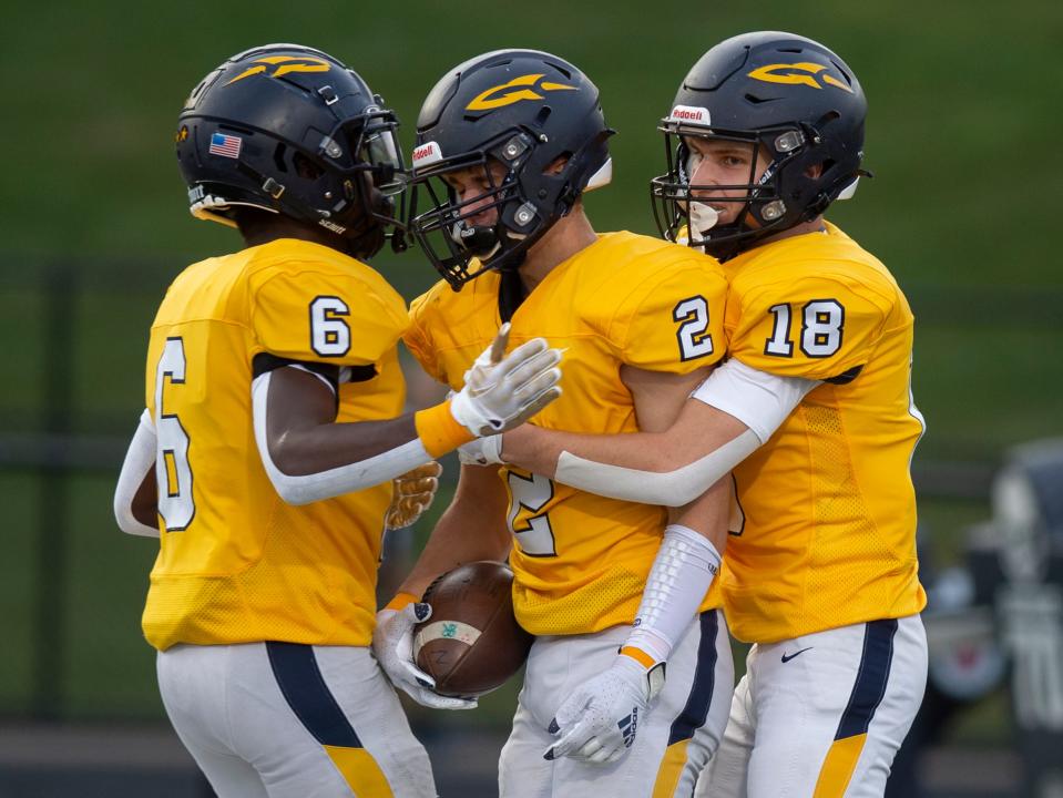 Streetsboro's Jermaine Price, Preston Hopperton and Jake Marshall celebrate in the end zone after Hopperton's touchdown in the first minutes of the game.