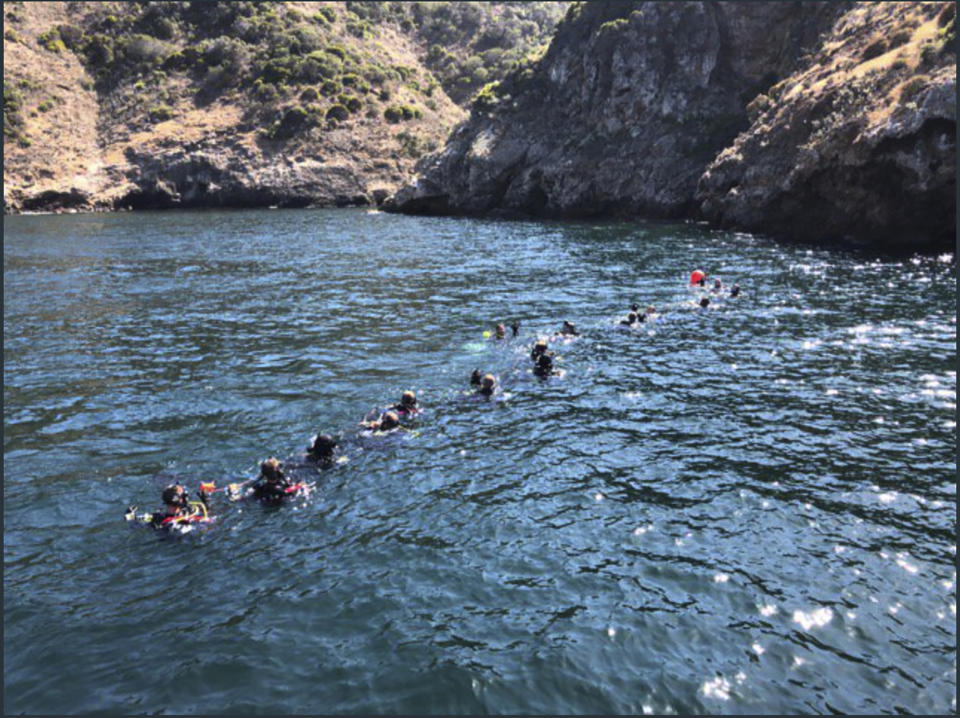 FILE - This Wednesday, Sept. 4, 2019, file photo provided by Santa Barbara County shows divers and support crews from many agencies working the scene of the Conception dive boat fire off Santa Cruz Island, Calif. Federal investigators say all six crew members were asleep when a fire broke out in the scuba diving boat off the coast of California, killing 34 people. (Santa Barbara County via AP, File)