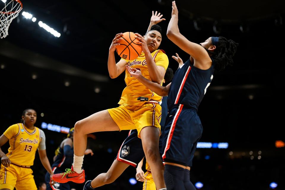 USC Trojans guard JuJu Watkins (12) grabs a rebound against UConn Huskies guard KK Arnold (2) during the first half of their Elite Eight game in the Portland Regional.