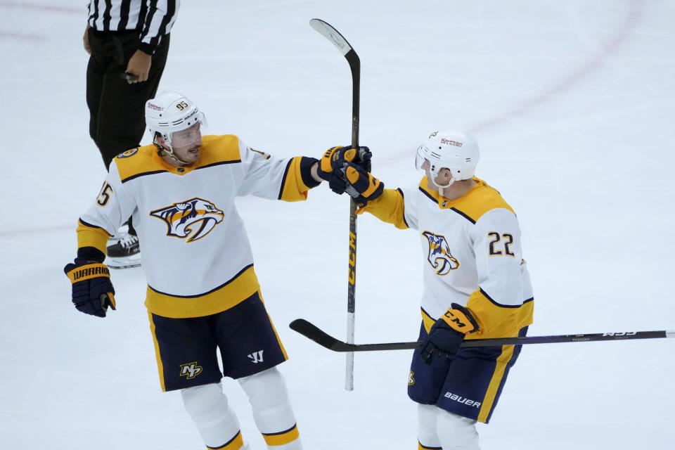 Nashville Predators' Tyson Barrie (22) celebrates after his goal with Matt Duchene during the second period of an NHL hockey game against the Chicago Blackhawks, Saturday, March 4, 2023, in Chicago. (AP Photo/Charles Rex Arbogast)