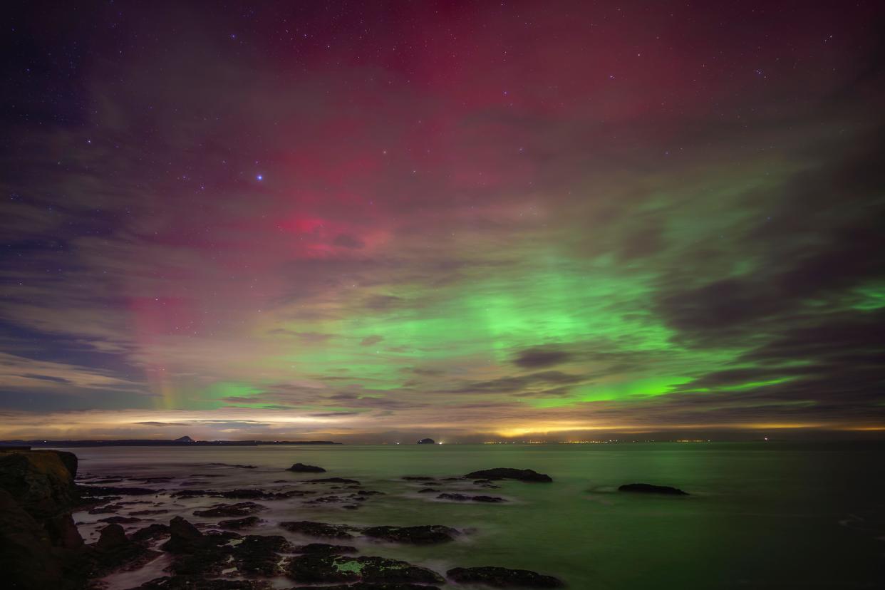 UK, Scotland, Dunbar, Long exposure of Aurora Borealis over Firth of Forth at night