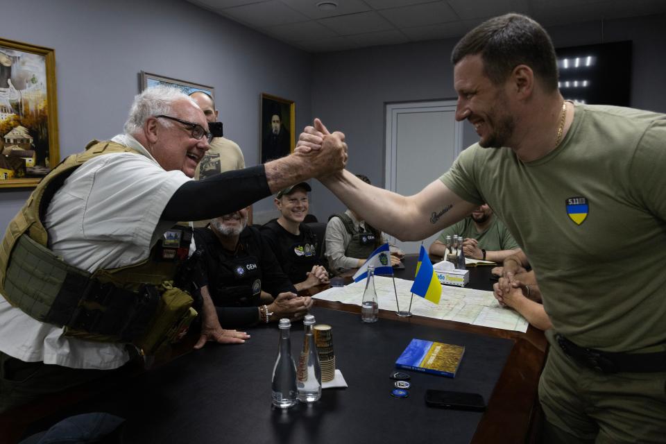 On a humanitarian mission, Howard G. Buffet (left) shakes hands with Kherson Governor Oleksandr Prokudin as they hold a meeting concerning reconstruction efforts after the devastating floods, on June 20, 2023, in Kherson, Ukraine.