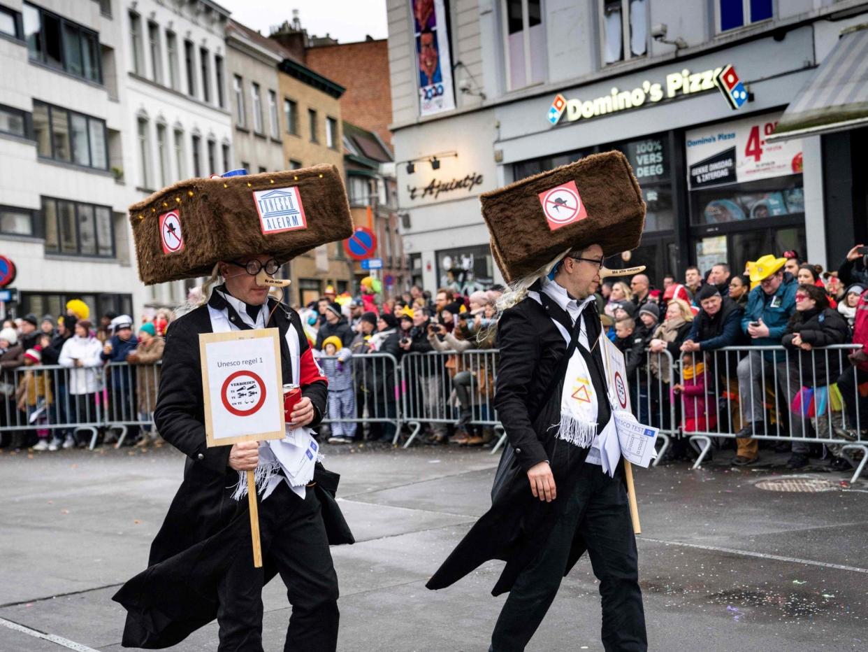 Costumed revellers parade during the 'Zondagsstoet' on the opening day of the Aalst carnival: AFP via Getty Images