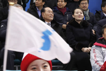 Ice Hockey – Pyeongchang 2018 Winter Olympics – Women Preliminary Round Match - Switzerland v Korea - Kwandong Hockey Centre, Gangneung, South Korea – February 10, 2018 - Kim Yong Nam and Kim Yo Jong look on as a unification flag is waved. REUTERS/Grigory Dukor