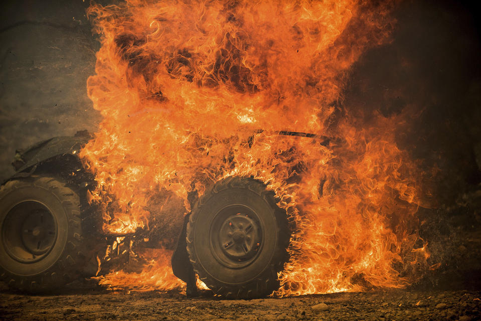 <p>Flames from a wildfire consume an all-terrain vehicle near Oroville, Calif., on Saturday, July 8, 2017. Residents were ordered to evacuate from several roads in the rural area as flames climbed tall trees. The California Department of Forestry and Fire Protection reported that several residents and one firefighter suffered minor injuries. (AP Photo/Noah Berger) </p>