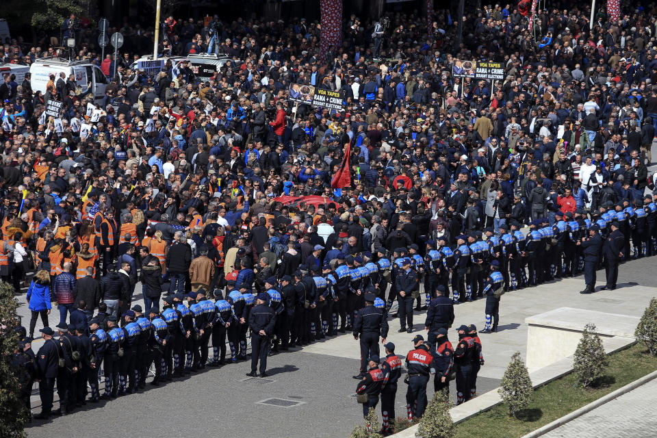 Protesters gather outside the Prime Minister's office during an anti-government rally in Tirana, Albania, Saturday, March 16, 2019. Thousands of supporters of the center-right Democratic Party-led opposition have gathered on Saturday in front of Socialist Party's Prime Minister Edi Rama to demand his resignation, a transitory Cabinet without him that will prepare fresh elections. (AP Photo/ Hektor Pustina)