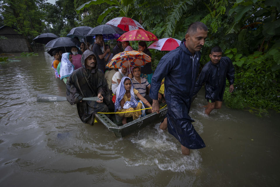 Indian army personnel rescue flood-affected villagers on a boat in Jalimura village, west of Gauhati, India, Saturday, June 18, 2022. (AP Photo/Anupam Nath)