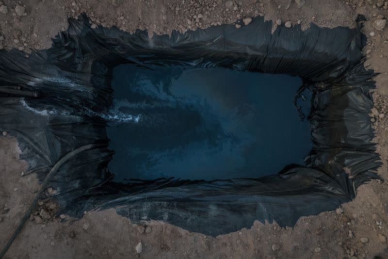 Produced water from well blowout flows into pit on a ranch in Pecos County, Texas