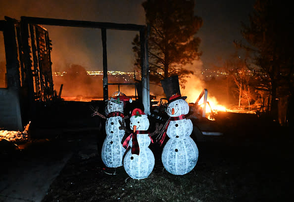 Christmas decorations stand outside a home destroyed by the fire. (RJ Sangosti/MediaNews Group/The / Denver Post via Getty Images)