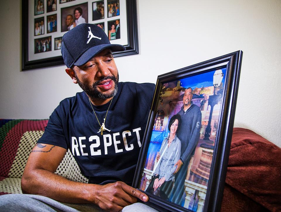 Eric Porter of Mesa holds a photo of himself and his wife, Amy, who died in October 2017. Porter had to fight to receive his wife’s life insurance benefits after her death.