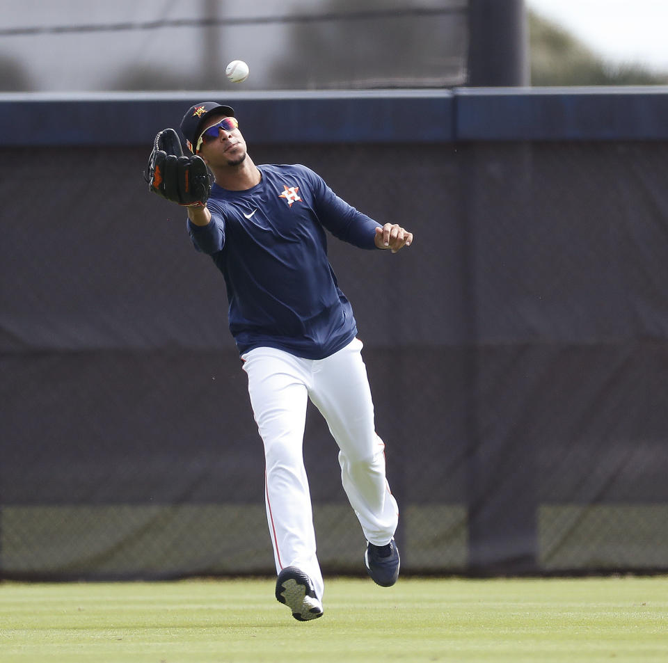 Houston Astros outfielder Michael Brantley catches a ball during baseball spring training in West Palm Beach, Fla., Tuesday, Feb. 23, 2021. (Karen Warren/Houston Chronicle via AP)