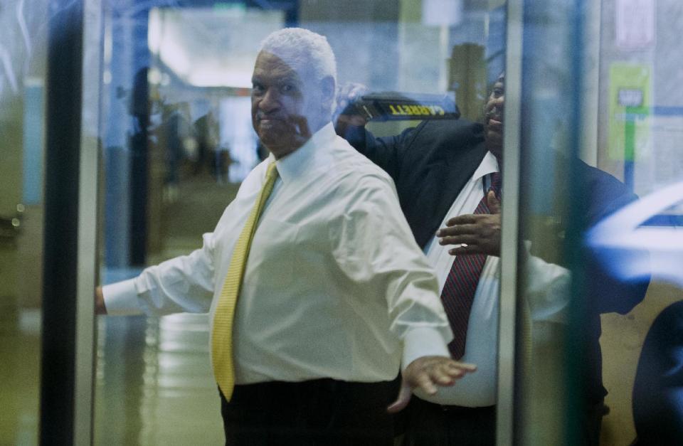 This photo taken through a courthouse window shows Washington businessman Jeffrey Thompson checked by security as he enters the federal courthouse in Washington, Monday, March 10, 2014. Thompson was charged Monday with conspiracy to violate federal and local campaign finance laws by funding off-the-books campaign activity for candidates including Hillary Rodham Clinton and district Mayor Vincent Gray. after being charged this morning in a criminal information with two conspiracy offenses stemming from an ongoing investigation . Thompson is suspected of funneling illicit funds into Mayor Gray's campaign.(AP Photo/Cliff Owen)