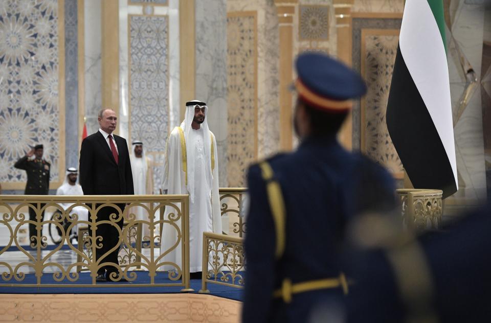 Russian President Vladimir Putin, left, and Abu Dhabi Crown Prince Mohamed bin Zayed al-Nahyan listen to the national anthem during the official welcome ceremony in Abu Dhabi, United Arab Emirates, Tuesday, Oct. 15, 2019. (Alexei Nikolsky, Sputnik, Kremlin Pool Photo via AP)