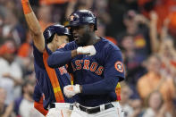 Houston Astros' Yordan Alvarez, right, celebrates his two-run home run against the Seattle Mariners with teammates during the sixth inning in Game 2 of an American League Division Series baseball game in Houston, Thursday, Oct. 13, 2022. (AP Photo/David J. Phillip)