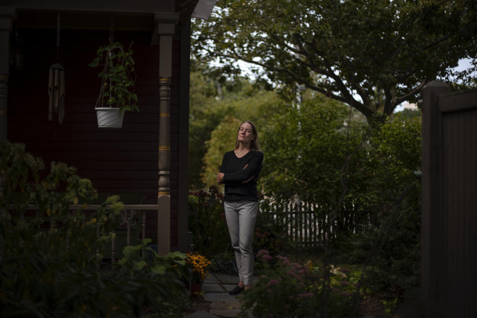 Charlotte Breed Handy, 57, a direct descendant of a Pilgrim who came over on the Mayflower, stands for a portrait outside her home in Providence, R.I., Tuesday, Sept. 22, 2020. "When I look back on my ancestry to the Mayflower, I do feel a little bit of ambivalence about it. But I also have a sense of pride about it from that side of my family, my dad's side. But I do feel like there's so much left out in terms of history when you follow a patriarchal line back. You're leaving out all the women that were pulled along the way," said Breed Handy. "I think that while it's good to take pride in your own culture and your own, whatever your feeling part of that, you're careful to respect other people's realities and cultures and way of being in the world, because there are a lot of different ways to be in the world." (AP Photo/David Goldman)