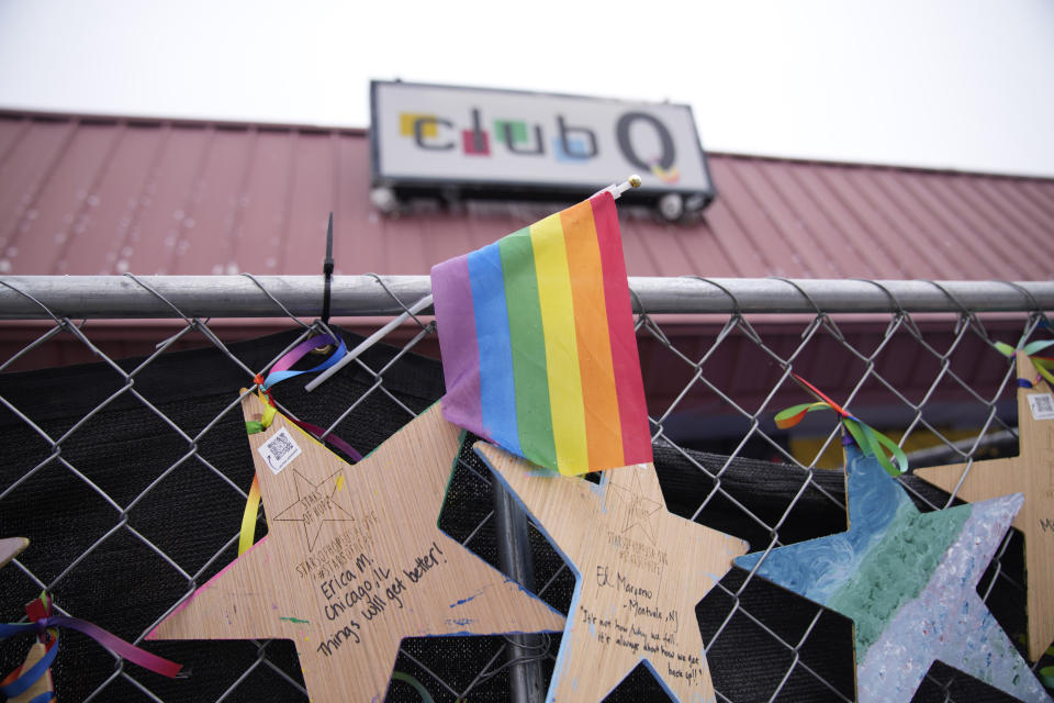 FILE - Tributes hang on a fence outside of Club Q on Feb. 22, 2023, in Colorado Springs, Colo. A New York woman has been indicted for making threats against LGBTQ businesses in the Denver area in the days after five people were killed at the gay club in Colorado Springs last year. Sharon Robinson appeared in federal court in Brooklyn Wednesday, May 24, 2023. (AP Photo/David Zalubowski, File)