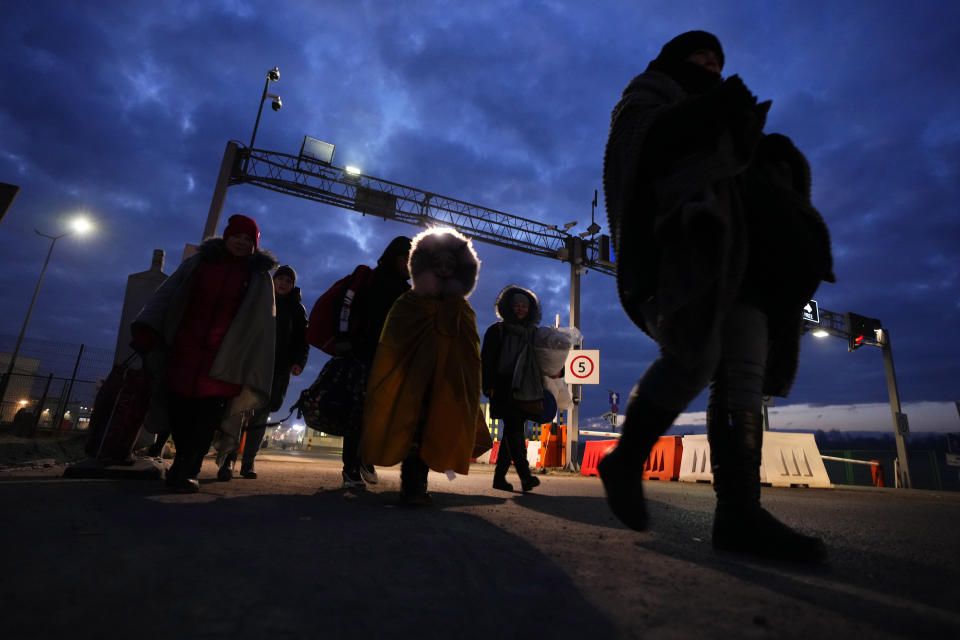 FILE - Refugees fleeing conflict in neighboring Ukraine arrive to in Przemysl, Poland, Feb. 27, 2022. Nearly a year has passed since the Feb. 24, 2022, invasion sent millions of people fleeing across Ukraine's border into neighboring Poland, Slovakia, Hungary, Moldova and Romania. (AP Photo/Petr David Josek, File)