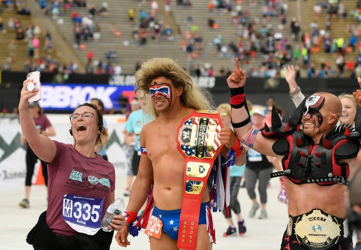 <span class="article__caption">Anna Yensen, left, takes a selfie with the Ultimate Warrior, middle, and Animal Lod, right, at the finish line of the Citizen’s race of the Bolder Boulder on May 27, 2019 in Boulder, Colorado. </span> (Photo: Helen H. Richardson/MediaNews Group/The Denver Post via Getty Images)