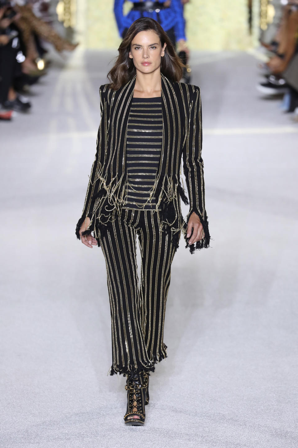 <p>The VS vet looked chic in stripes on Balmain's Paris Fashion Week runway.</p>
